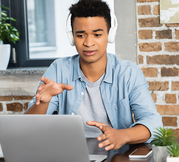 Man in front of his laptop with hand gesture